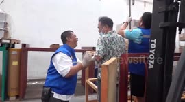 Rescue team use cherry picker to pull 12ft python from warehouse ceiling