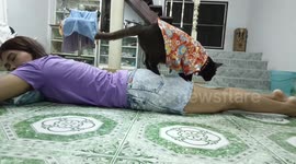 Loving pet cat massages tired owner’s legs