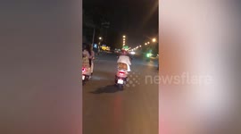 Pet cat rides pillion on the back of moped in Thailand