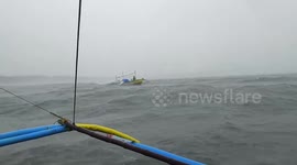 Fishermen brave rough seas during Typhoon Amang in the Philippines