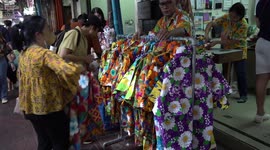 Shops sell water guns and floral shirts for Songkran festival in Thailand