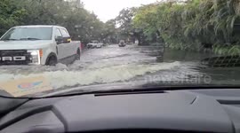Cars and trucks stuck on flooded road as torrential rains hit Florida