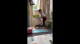 Little boy throws a tantrum when he cannot pass the chair through a door
