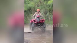 Woman goes head over handlebars into muddy puddle in hilarious quad bike fail