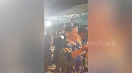 Reveller shows off impressive balancing skills as she dances with drink on her head