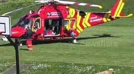 The Air Ambulance attempting a dangerous landing on the playing fields at Port isaac in cornwall then waiting for the ambulance 2