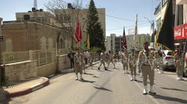 Palestinian scout bands parade during the Holy Fire ceremony in the West Bank city of Ramallah