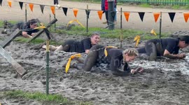 Contestants get hard time at barbed wire challenge in Tough Mudder run in London
