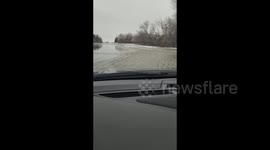 Minnesota motorist records as they drive through submerged roads as floods strike state