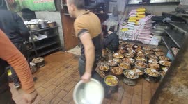Palestinian chefs prepare al-Qudra meal (meat and rice) of the daily 'iftar' (fast breaking) meal during the Muslim holy month of Ramadan