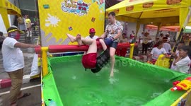 Tourists join amusing sea boxing attraction at Buddhist Songkran Festival