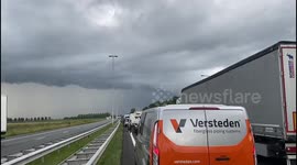 Standing in a traffic jam on the high way and this scary looking thunder clouds came at us,