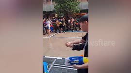 Snake sparks panic when it emerges on road during Songkran celebrations in Thailand