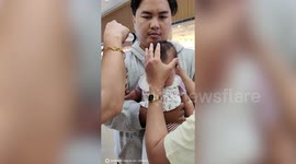 Baby hilariously gives woman death stare during ear piercing