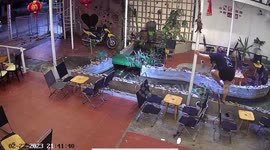 Woman slips into water while jumping over restaurant pond