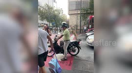 Adorable pet dog stands on hind legs riding pillion with owner in Argentina