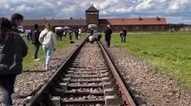 New footage shows woman setting up her controversial posed shot outside Auschwitz