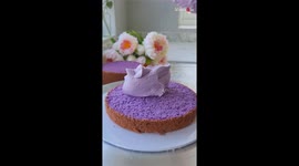 Cake artist beautifully decorates an Ube cake with heavenly toping and frosting