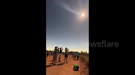Timelapse captures hybrid solar eclipse as skygazers flock to witness celestial event in Australia