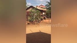 Villagers carry entire wooden house on their backs