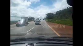 Close Call: Truck in Opposite Lane Overtaking Nearly Causes a Head-On Collision