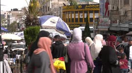 Palestinians shop at a market ahead of Eid al-Fitr in the West Bank city of Ramallah
