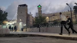 Palestinian Muslim worshipers perform the Eid al-Fitr prayer celebrating the end of the holy Muslim fasting month of Ramadan in Ibrahimi Mosque