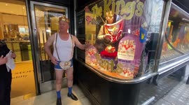 Crowned man in his underwear stands outside London bookstore ahead of coronation day