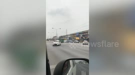 Passing motorists stop to help delivery rider when his cargo caught fire