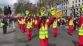 Protesters dressed as 'climate wardens' march in London to end fossil fuel era