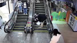 Heroic mall worker saves elderly woman and child from escalator fall in China