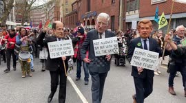 Protesters wearing King Charles, Prince William, and Prince Harry masks demonstrate during London march