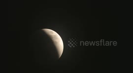 Full Blood Moon Lunar eclipse with Earthshine - zoomed close up - time lapse