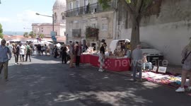Locals shop for vintage wares at flea market in Lisbon, Portugal
