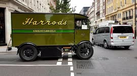 A Harrods Service Team Retro Van Seen Passing A Row Of Designer Shops In Sloane Street, And Heading Toward Sloane Square In Chelsea