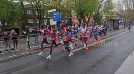 Elite women and men athletes pass through Bermondsey during the London Marathon