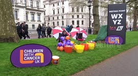 Children With Cancer UK charity fundraising in the rain St James's Park during 2023 TCS London Marathon