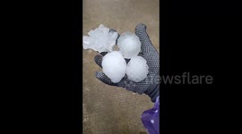 Motorists use pillows to shelter as HUGE hailstones smash through car's windscreen in China