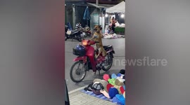 Pet dog sits on motorcycle waiting for owner outside shop