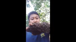This man's hand is COVERED in bees