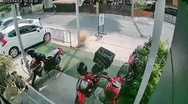 CCTV footage shows street vendor divebombed by angry bee swarm in Thailand