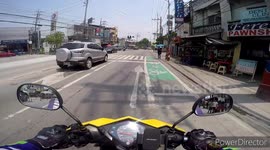 Kind motorcycle rider helps elderly woman cross busy road
