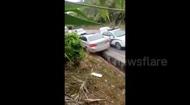Watch stolen BMW swerve into drainage ditch to avoid police in southern China
