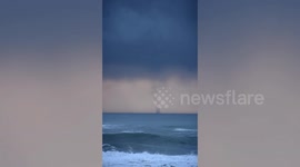 Waterspout tornado forms under massive eerie dark clouds in California