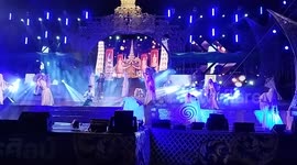 Performers in elaborate costumes perform on stage at an Isaan Mor Lam concert in Pattaya, Thailand