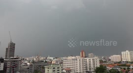 Dark storm clouds blanket Bangkok relieving city from scorching weather