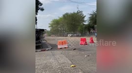 Leaves fly as dust devil whirls on road in Thailand