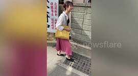 Tourist giggles as she steps on tickling massage walking path in Japan