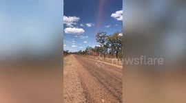 Brown dust devil delays passing tourists at Australian outback