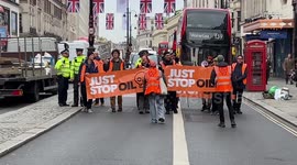 Angry motorists honk their horns and shout at Just Stop Oil activists who are blocking London's Strand